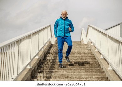 An active senior runner running down the stairs outside.