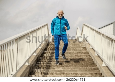 An active senior runner running down the stairs outside.