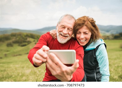 Active senior runners in nature taking photo with smart phone. - Powered by Shutterstock