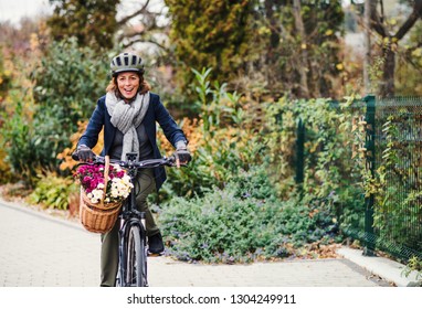 Active senior woman with electrobike cycling outdoors in town. - Powered by Shutterstock