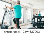 Active senior woman excercising on stepper at gym to stay fit. Cardio excercises for mature people. Athleticspirit concept
