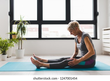 Active Senior Woman Practicing Yoga Indoors. Exercise For Older Adults