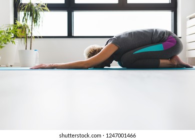 Active Senior Woman Practicing Yoga Indoors. Exercise For Older Adults