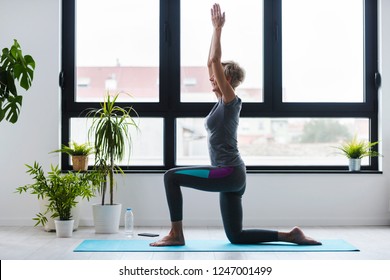 Active Senior Woman Practicing Yoga Indoors. Exercise For Older Adults