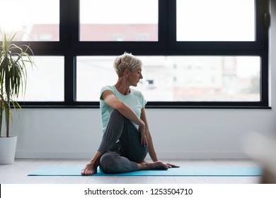 Active Senior Woman Practicing Yoga Indoors. Exercise For Older Adults