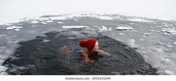 Active Senior Woman Swimming In Water Hole In Frozen Lake Outdoors In Winter, Cold Therapy Concept.