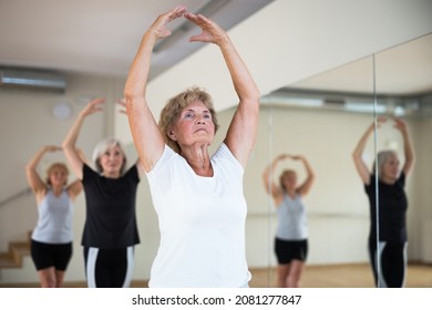 Active Senior Woman Visiting Choreography Class With Group Of Aged Females, Practicing Classical Ballet Technique.