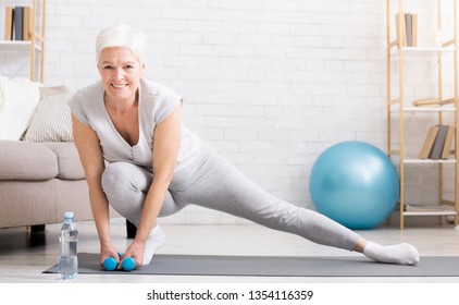 Active Senior Woman Warming Up, Doing Legs Stretching Exercises At Home, Panorama With Empty Space