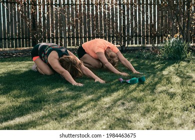 Active Senior Women 55-59 Years Perform Exercises While Lying On Grass