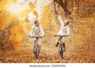 Active seniors on bikes in autumn nature - Powered by Shutterstock