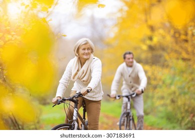 Active seniors riding bikes in autumn nature. They having romantic time outdoor.
 - Powered by Shutterstock