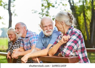 Active Seniors Talking As Friends On A Summer Outing