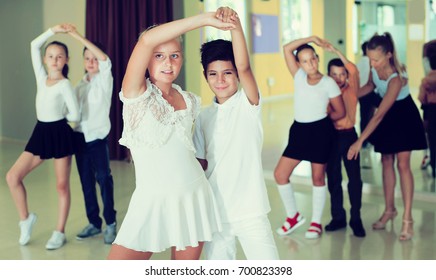 Active Smiling Children  Enjoying Of Partner Dance In Class