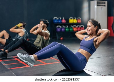 Active Sportsman and woman sit-up on floor for abs workout in stadium. Group of multiethnic fitness trainer bodybuilder people doing cardio exercise to build muscle for health care lifestyle in gym. - Powered by Shutterstock