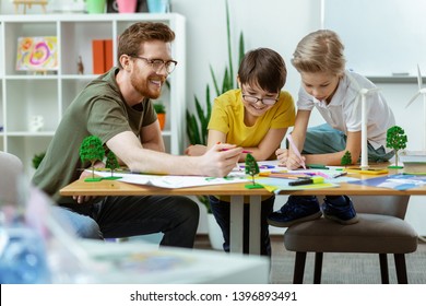 Active students. Contented school group actively working on creating informative poster about environmental issues - Shutterstock ID 1396893491