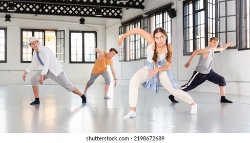 Active Teenage Dancers Having Contemporary Dance Training At Dance Hall
