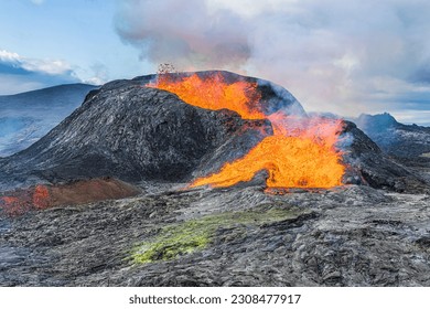 Active volcano on Reykjanes Peninsula. Landscape in Iceland. Lava from the volcanic crater in the day with sunshine. old magma rock at volcanic crater. Rising steam from the crater