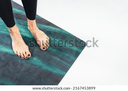 Active woman exercising on joga mat, Woman feets on yoga mat doing workout