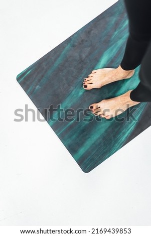 Active woman exercising on joga mat, Woman feets on yoga mat doing workout