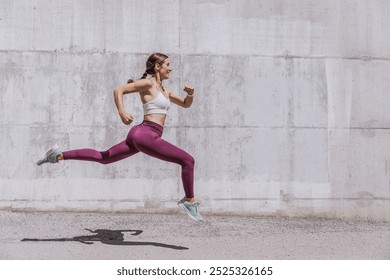 Active woman exercising outdoors. Healthy young female athlete running. Smiling sportswoman do functional training outside on bright sunny day,  wearing sport outfit. - Powered by Shutterstock