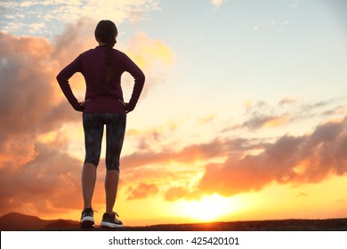 Active Woman Looking Ahead At Sunset Sky For Life Challenge. Runner Athlete Getting Ready For Trail Run Thinking Goal Achievement Choice And Happiness. Female Sports Person Living Healthy Lifestyle.