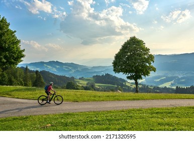 active woman riding her electric mountain bike in the Brenz Forest mountains near Sulzberg, Vorarlberg, Austria - Powered by Shutterstock