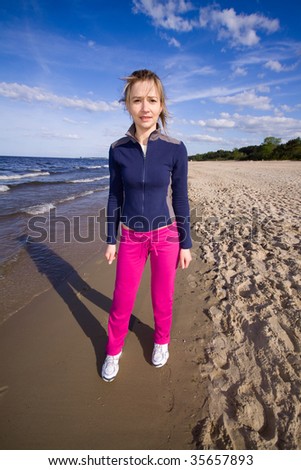 Active woman running on the beach