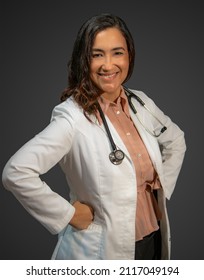 Active Woman Series. Woman Doctor With Hispanic Latin Features, Smiling And Pretty Dressed In A Doctor's Uniform And A Stethoscope. Concept Health, Inclusion, Professional Woman