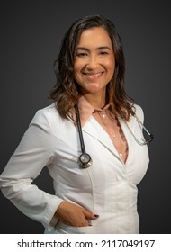 Active Woman Series. Woman Doctor With Hispanic Latin Features, Smiling And Pretty Dressed In A Doctor's Uniform And A Stethoscope. Concept Health, Inclusion, Professional Woman