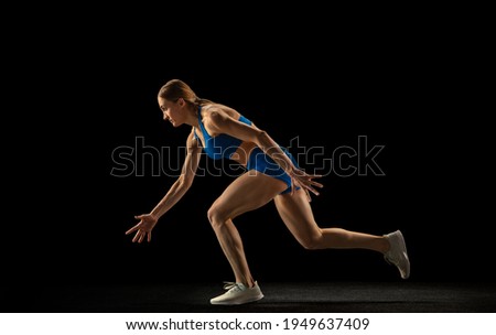 Similar – One young middle age athletic, woman training, exercising with fitness jumping rope over dark background, full length front view, looking at camera