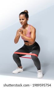 Active Woman Using A Hip Band In A Squat Position Mockup