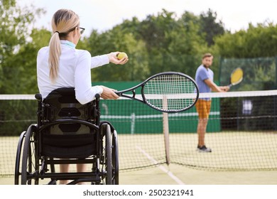 An active woman in a wheelchair preparing to play tennis with a standing partner on an outdoor court showcasing inclusion and adaptability in sports. - Powered by Shutterstock