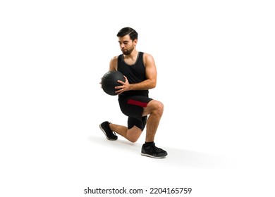 Active young man making leg lunges exercises and using dumbbell weights for his cross training workout - Powered by Shutterstock