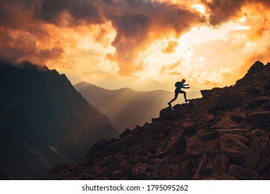 Active young man run on the top of the hill. Sunset mountains in background. Slovakia, High Tatras - Shutterstock ID 1795095262