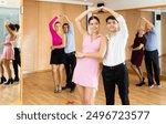 Active young pair practicing ballroom dance in training hall during dancing-classes. Pairs training ballroom dance