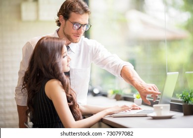 Active and Young Smart Confident Businessman Helping new Woman Worker.Business Freelanc Co-Working Space Luxurious Serviced Office For Rent Concept. Setup studio shooting.