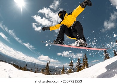 Active young snowboarder jumps from the kicker at ski resort. Winter sports active weekend concept