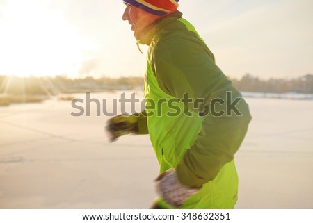Active young sportsman running outdoors
