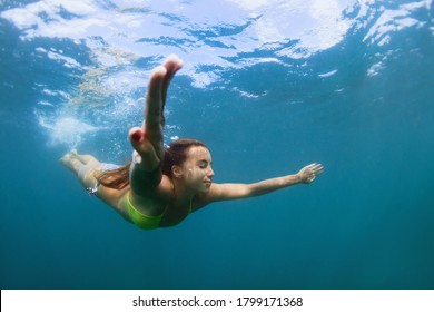 Active Young Woman Jump And Dive Underwater In Tropical Sea . Travel Lifestyle, Water Sport, Snorkeling Adventure. Summer Sea Beach Vacation .