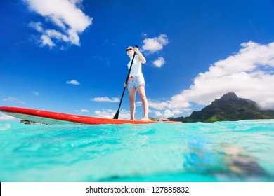 Active Young Woman On Stand Up Paddle Board