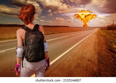 Active Young Woman In Sportswear Looking At Distant Nuclear Explosion In The Field. Fantastic Apocalyptic Landscape