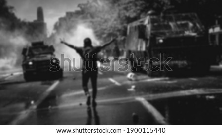 an activist are stand on riot situation with tear gas blur  . black and white blurry background 