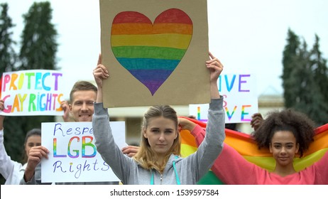 Activists Raising Posters And Rainbow Symbols, Rally March For LGBT Rights