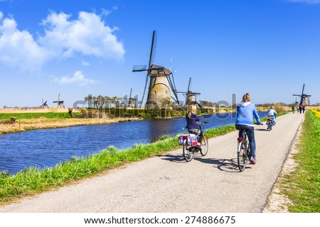 activities in Holland countryside. Cycling in Kinderdijk. Traditional dutch windmills
