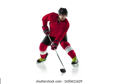 Activity. Male hockey player with the stick on ice court and white background. Sportsman wearing equipment and helmet practicing. Concept of sport, healthy lifestyle, motion, movement, action. - Powered by Shutterstock