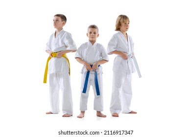 Activity. Three Sportive Kids, Little Boys, Taekwondo Or Karate Athletes In Doboks Posing Isolated On White Background. Concept Of Sport, Education, Skills, Martial Arts, Healthy Lifestyle And Ad.