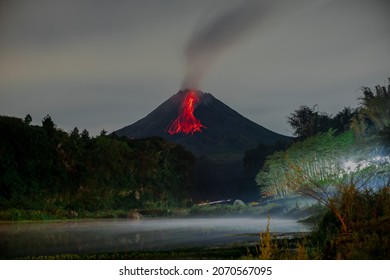 The activity of the volcano when it erupts and emits incandescent lava accompanied by hot clouds in the early morning - Shutterstock ID 2070567095