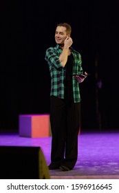 Actor dancer young man performs in the theater on stage in a dance musical show