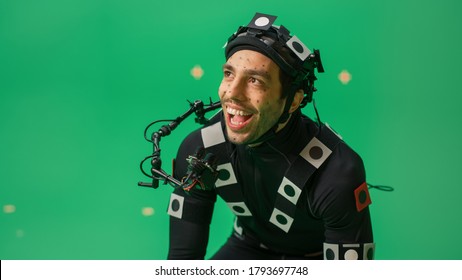 Actor Wearing Motion Caption Suit and Head Rig acts as an Animal or a Monster for CGI Green Screen Scene. Big Budget Filmmaking On Film Studio Set Shooting Blockbuster Movie with Chroma Key. - Shutterstock ID 1793697748