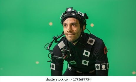 Actor Wearing Motion Caption Suit and Head Rig acts as an Animal or a Monster for CGI Green Screen Scene. Filmmaking On Film Studio Set Shooting Blockbuster Movie with Chroma Key. - Shutterstock ID 1793697754